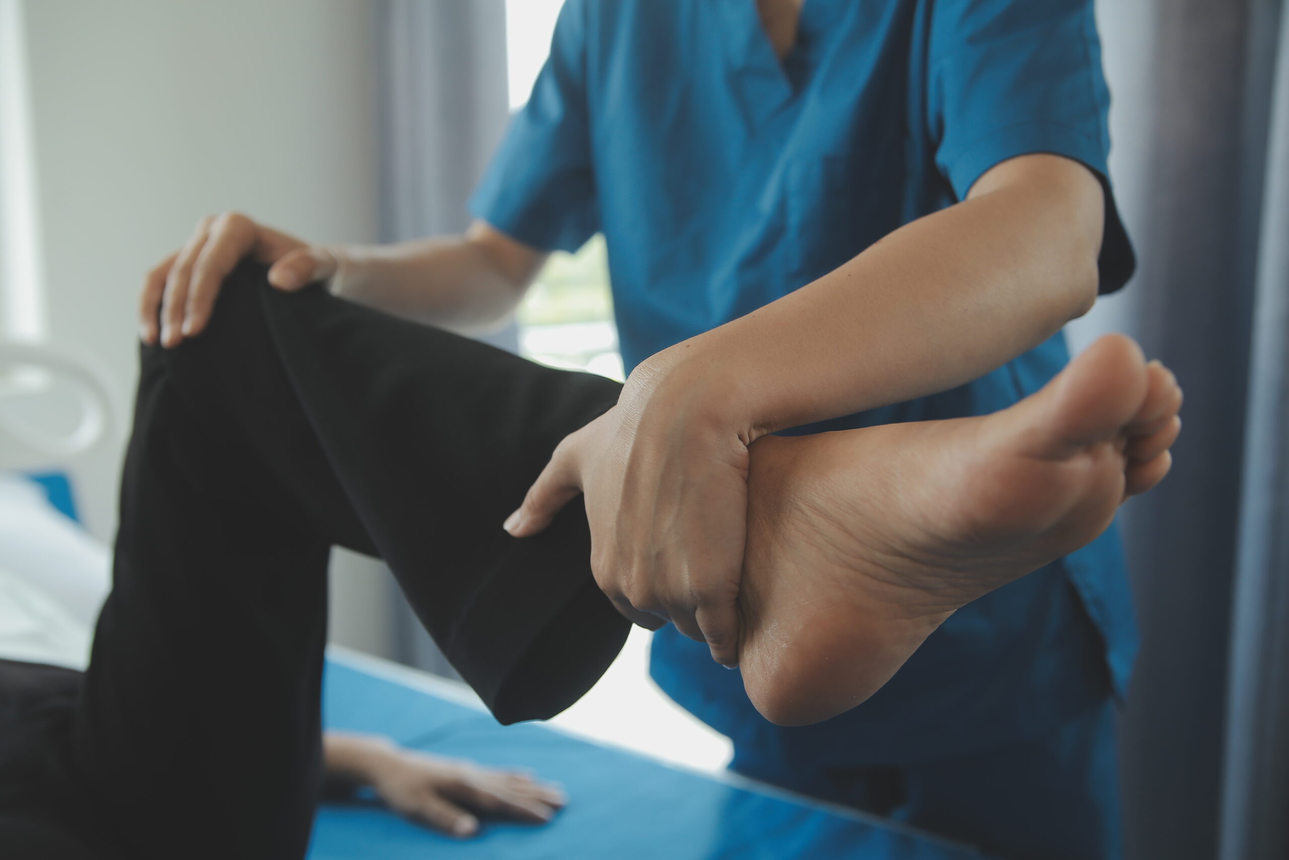Physiotherapist working with patient in clinic, closeup
